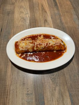 Cheesy enchilada on a white plate