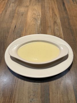 Bowl of creamy soup on plate