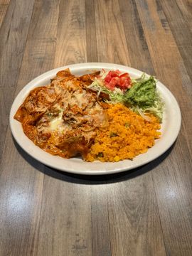 Enchiladas served with rice and vegetables