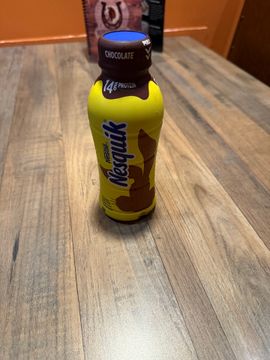Chocolate Nesquik bottle on wooden table
