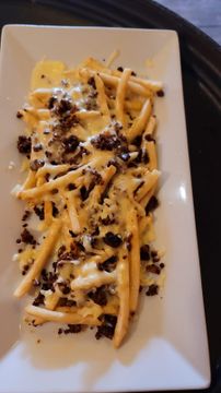 Loaded fries on white plate
