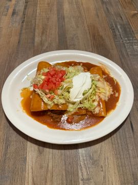 Enchiladas with toppings on a white plate.