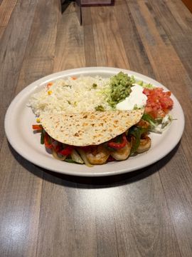 Taco with rice and toppings on plate