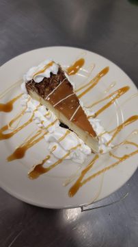 Plate of cheesecake and whipped cream