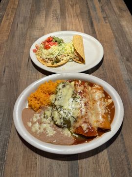 Tacos and enchiladas on wooden table