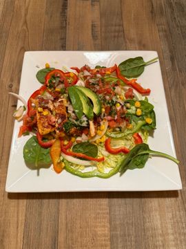 Fresh salad on square white plate