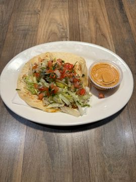 Fresh taco on plate with sauce