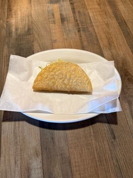 Single taco wrapped in paper