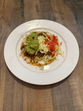 Crispy tostada topped with fresh toppings