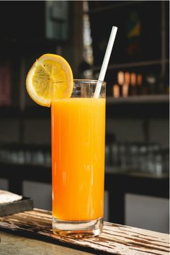 Bright orange beverage with straw