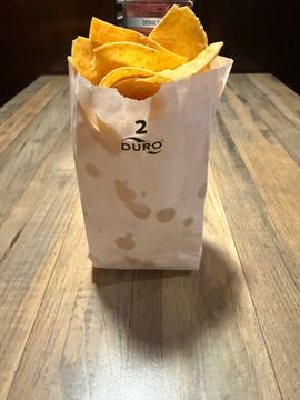 Tortilla chips in paper bag