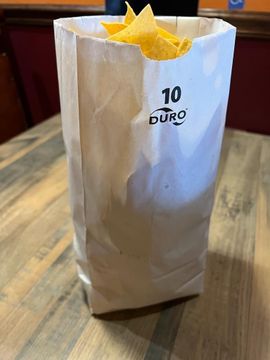 Paper bag filled with tortilla chips
