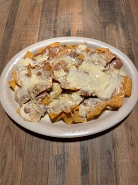 Cheesy nachos on a white plate
