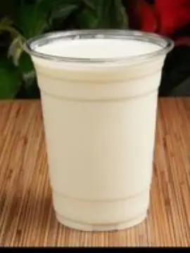 Clear plastic cup filled with milk