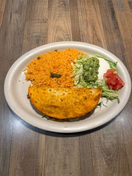 Plate of rice, taco, and toppings