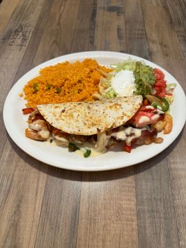 Plate of tacos, rice, and garnishes