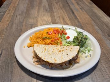Taco with rice and salad on plate