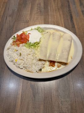 Enchilada plate with rice and garnish