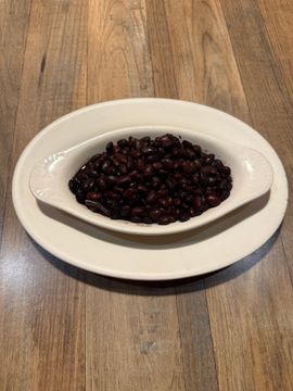 Cooked black beans on wooden table