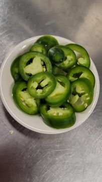 Sliced jalapeños in a bowl