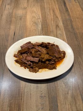Shredded beef dish on wooden table