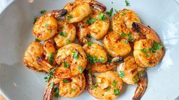 Grilled shrimp with herbs on plate