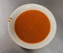 White bowl of tomato soup
