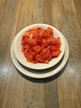 Fresh chopped tomatoes on wooden table