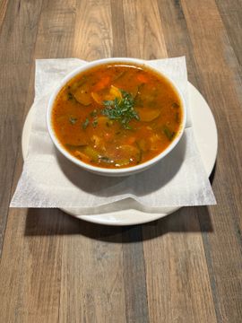 Fresh vegetable soup served in white bowl