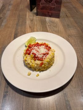 Corn dish garnished with lime wedge