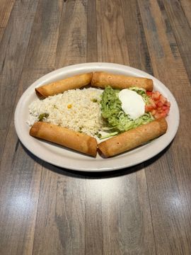 Taquitos served with rice and toppings