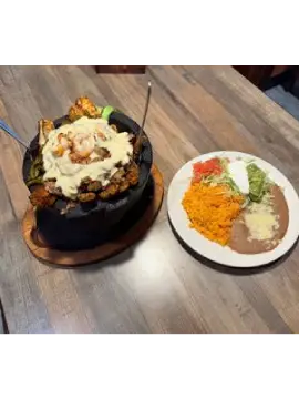 Mexican molcajete with shrimp, rice, beans
