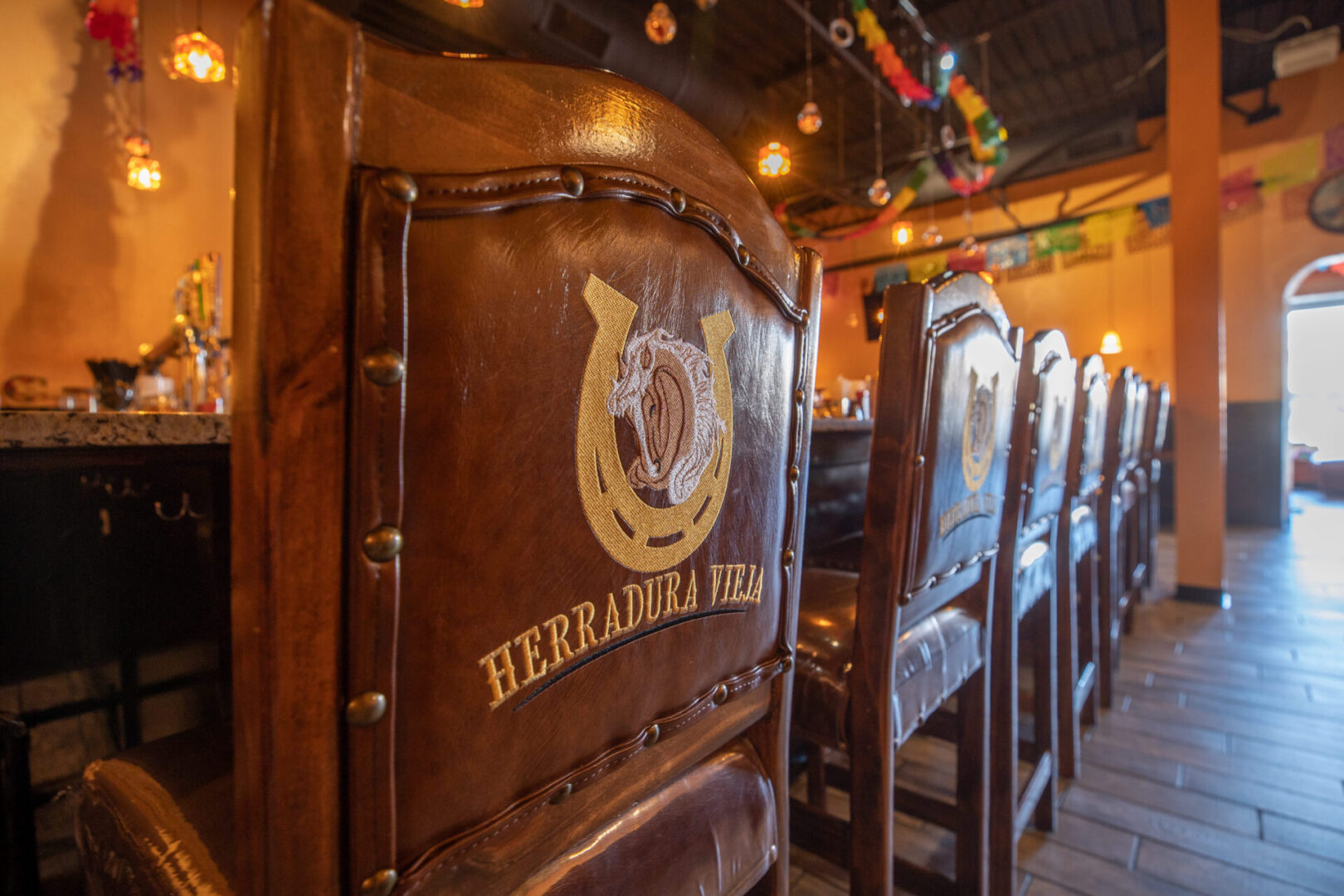 Leather bar chairs with horseshoe logo